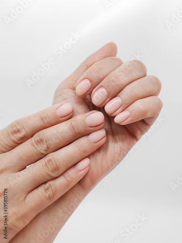 woman hands with beautiful natural manicure on white background