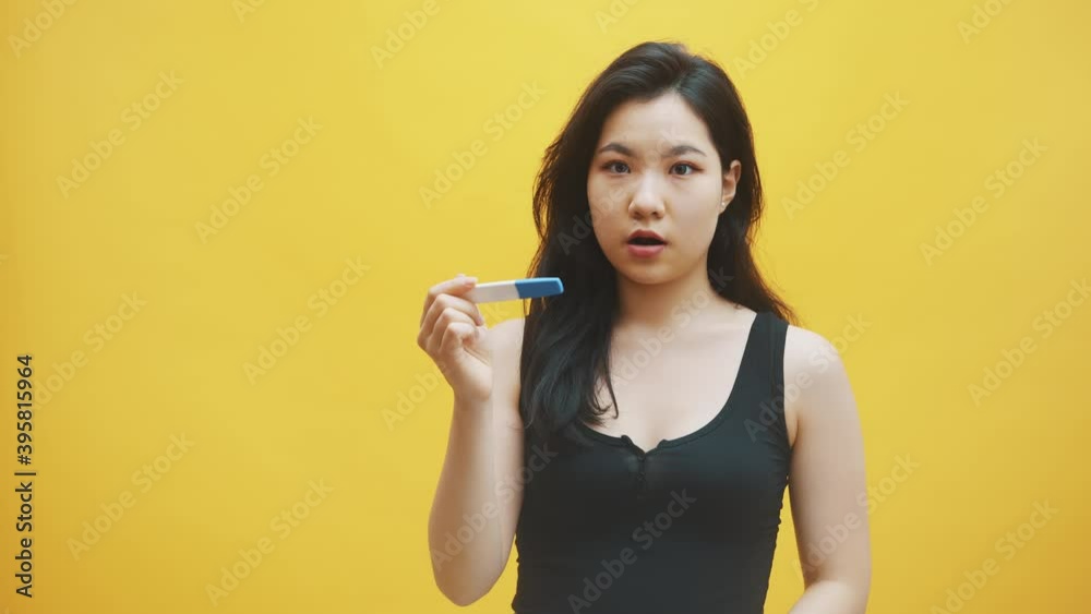 unwanted pregnancy concept. impatient young asian woman looking at the pregnancy test waiting for results. . High quality 4k footage unwanted pregnancy concept. impatient young asian woman looking at the pregnancy test waiting for results. . High quality 4k footage