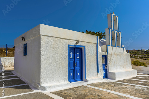 A view of a small church close to the settlement of Akortiri in Santorini in summertime photo