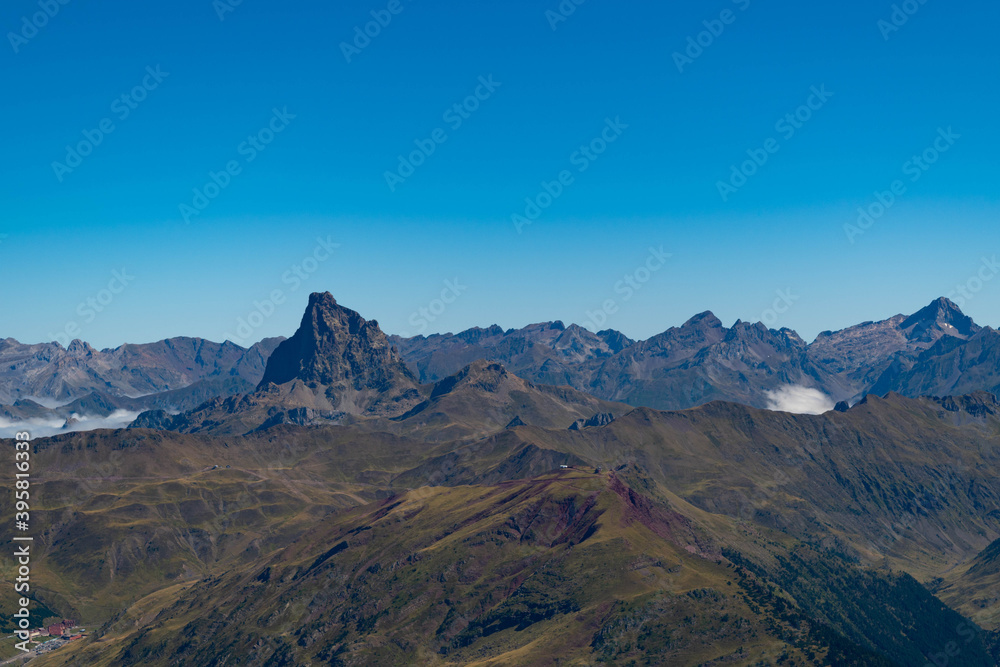 Views from the top of Aspe in the Pyrenees with mountains and peaks on the Spanish side and a sea of clouds on the French side and Midi d'Ossau in the front