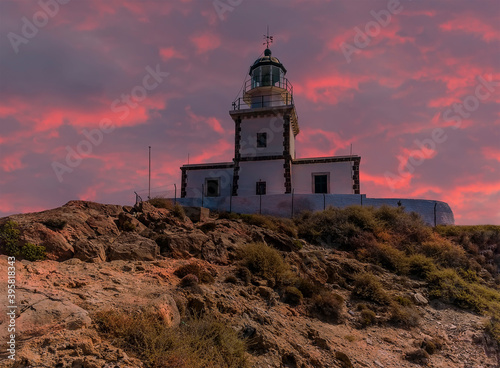 A view of the lighthouse at Akortiri in Santorini at sunset in summertime