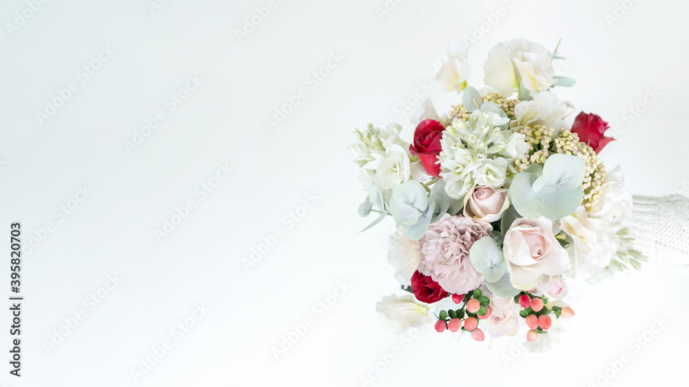 Fototapeta Horizontal banner with a beautiful delicate wedding bouquet made of artificial flowers. Copy or spare bouquet for the bride. Elegant bouquet in pastel shades with copy space for banners, invitations.