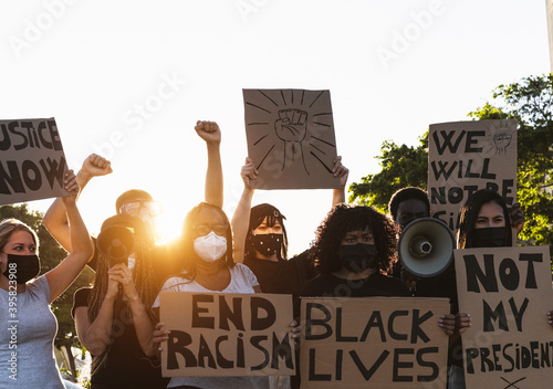 Activist movement protesting against racism and fighting for equality - Demonstrators from different cultures and race protest on street for equal rights - Black lives matter protests city concept