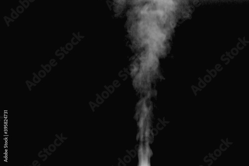 Blurry transparent white smoke blow up in the air on black background © Vipada