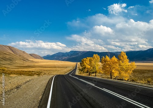 Asphalt road to the mountains. Mountain track on Altai. photo