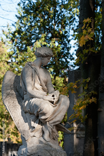 Tomb sculpture of a sitting angel at Lychakiv cemetery in Lviv, Ukraine