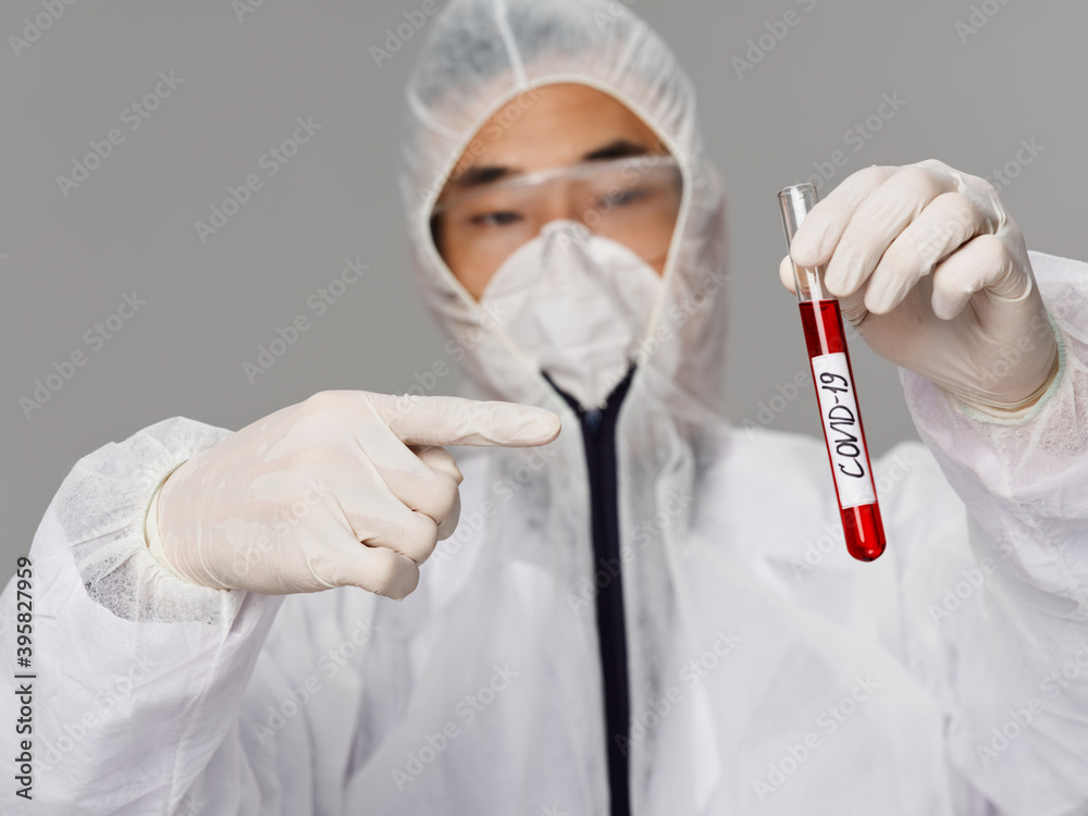 A male laboratory assistant points a finger at the covid-19 tests A male laboratory assistant points a finger at the covid-19 tests