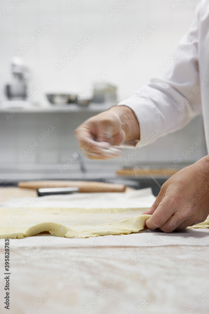 Chef Preparing Dough In Kitchen