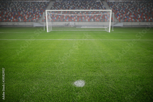 Fotografie Shallow depth of field (selective focus) image with the penalty kick point on an empty soccer stadium