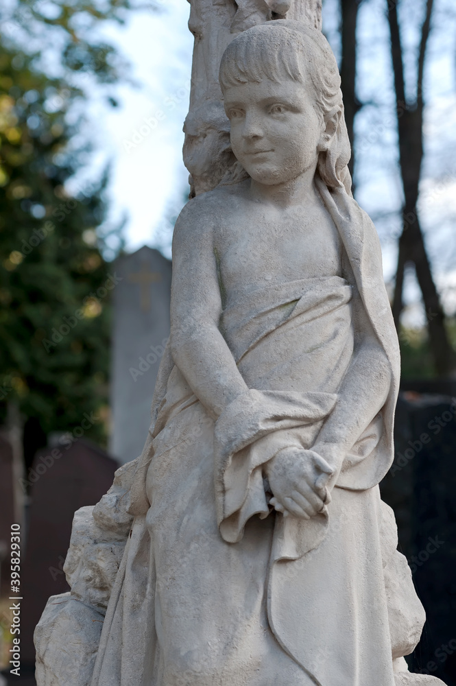 Fototapeta premium Tomb sculpture of a girl at Lychakiv cemetery in Lviv, Ukraine