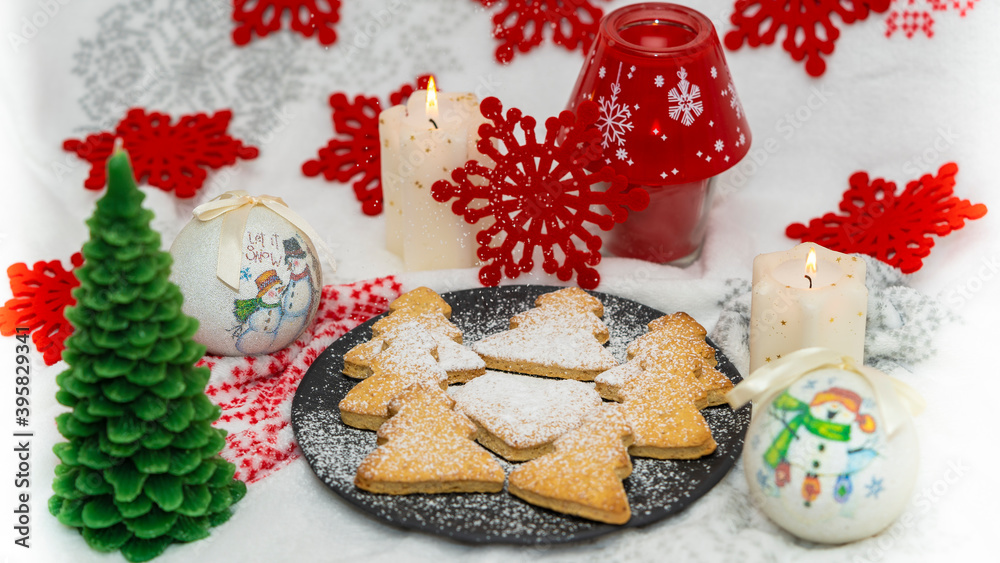 Christmas cookies with a background of globes, candles and red stars