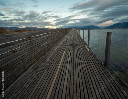 Stunning views of the historic wood bridge  Holzsteg  connecting the village of Hurden  Seedam  Schwyz with the city of Rapperswil  St. Gallen
