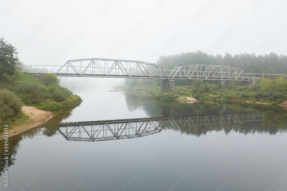 Fototapeta premium misty morning in the fog bridge over the river Gauja covered in the mist
