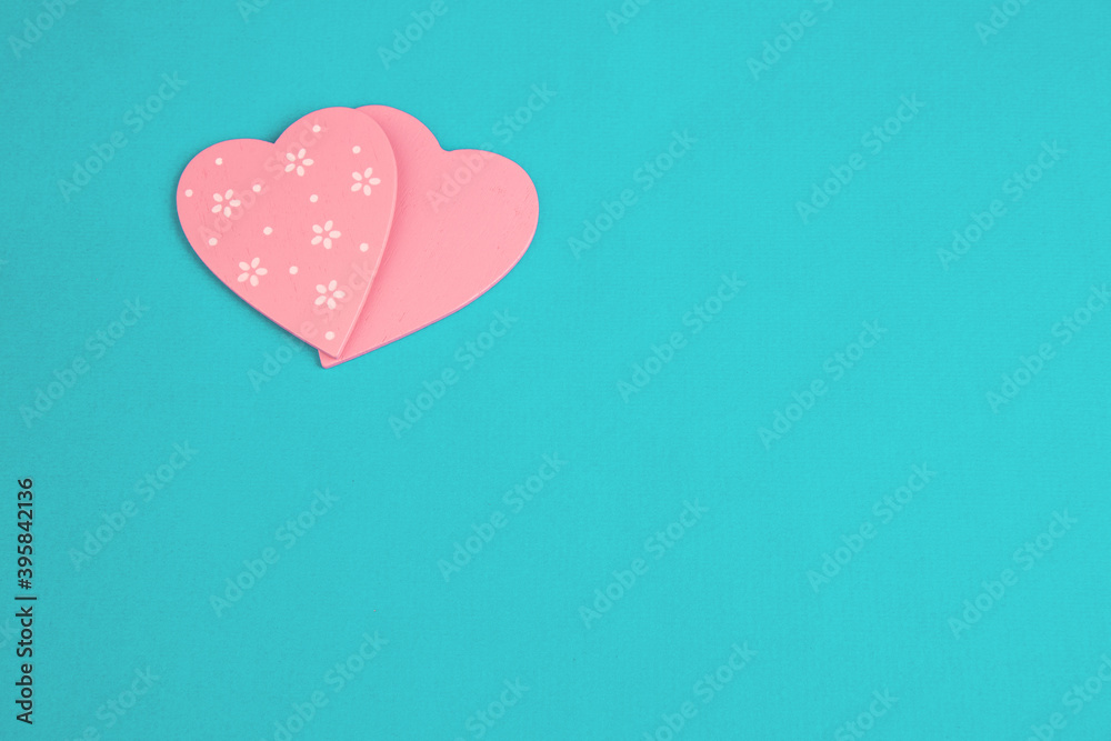 Two pink hearts on a turquoise background top view. Copy space. Greeting card or banner. Flat Ley Two pink hearts on a turquoise background top view. Copy space. Greeting card or banner. Flat Ley