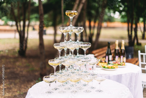 Wedding cascade of glasses with champagne at the celebration