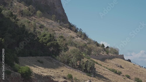 Landscape of a mountain with cars going down and a motorcycle going up