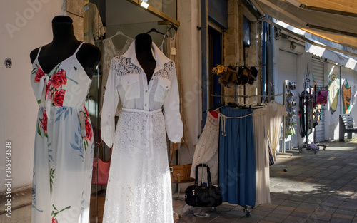April 22, 2019, Limassol, Cyprus. Mannequins in women's dresses at the entrance to a store on a quiet tourist street. © fifg