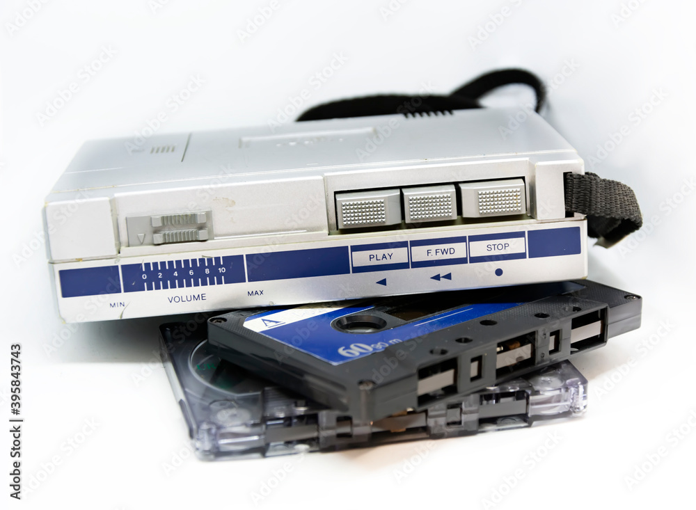 Old portable stereo audio tape cassette player isolated on a white background. Obsolete technology. 80s. Listening to music. Old portable stereo audio tape cassette player isolated on a white background. Obsolete technology. 80s. Listening to music.