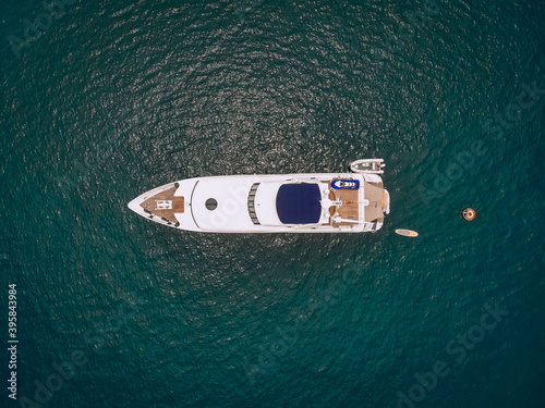 Drone shot of the beautiful white yacht in the warm blue sea  millionaire concept. © Semachkovsky 