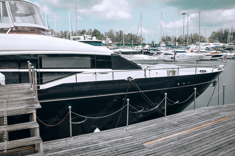 Fototapeta premium Front of a luxury yacht parked in the parking lot on the water, sharp nose of the yacht