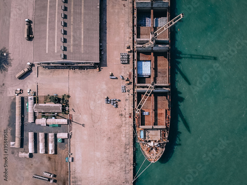 Aerial top view of factory big ship in the port parking