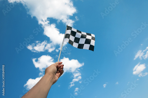 hand holding a checkered flag © alesmunt
