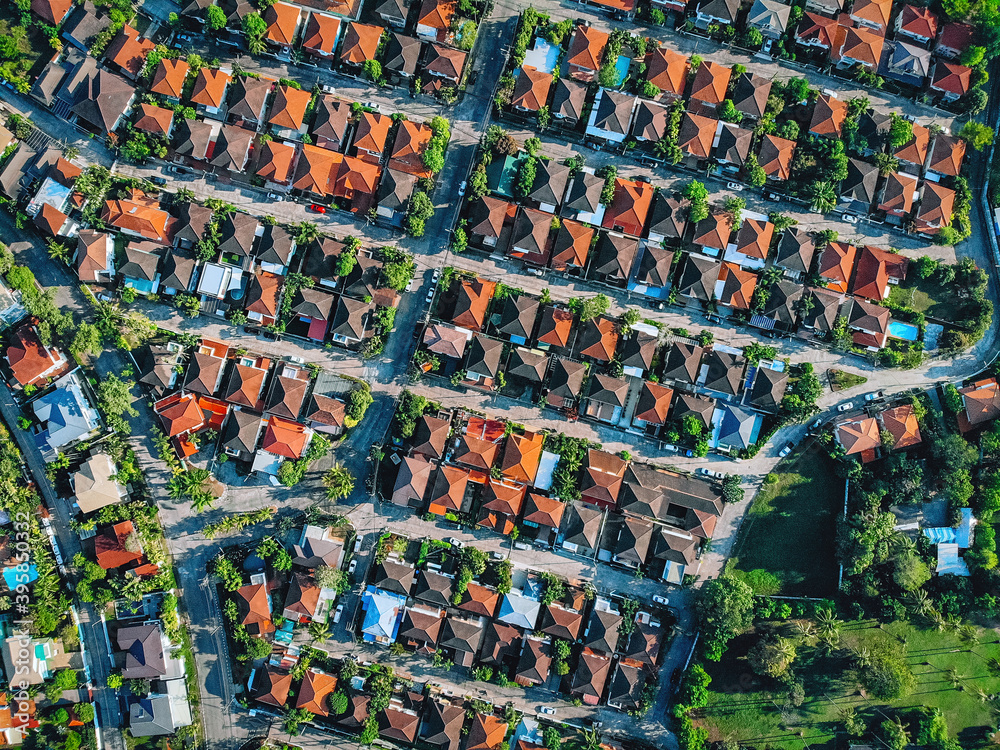 Fototapeta premium Aerial, bird view of the old european city with red tiled roofs of neighborhood family houses, background