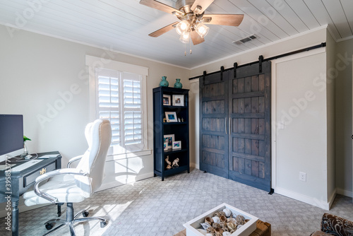 Modern Home Office with Custom Barn Doors and Shelves
