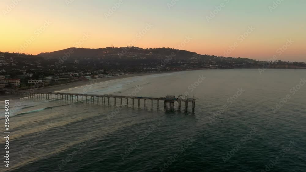 Flying Towards Scripps Pier Over Tranquil Ocean In La Jolla, San Diego During Sunrise. - Aerial Drone Shot Flying Towards Scripps Pier Over Tranquil Ocean In La Jolla, San Diego During Sunrise. - Aerial Drone Shot