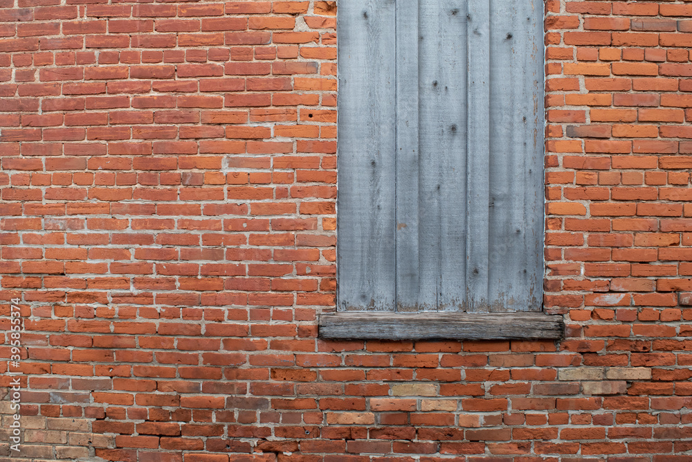 Weathered wooden window with brick wall
Weathered wooden window with brick wall