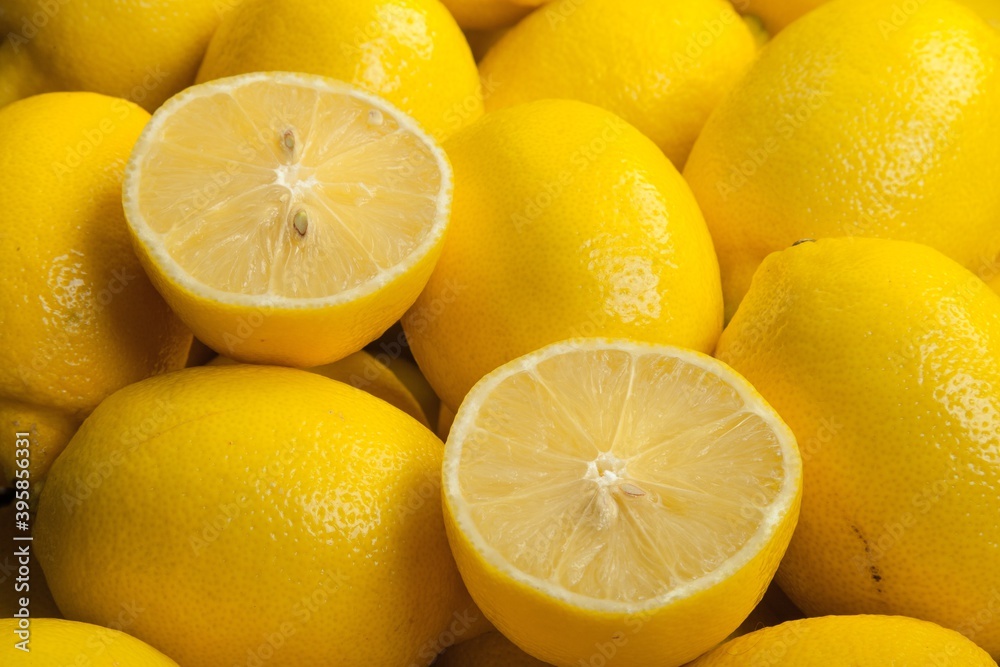 Chopped lemon halves on whole lemon Chopped lemon halves on whole lemon
