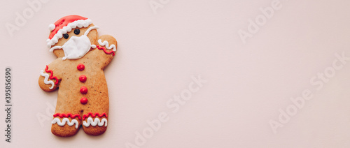 Xmas set of cookies, gingerbread man in face mask, gingerman in a protective mask on a white snow background, minimal seasonal pandemic winter holiday banner