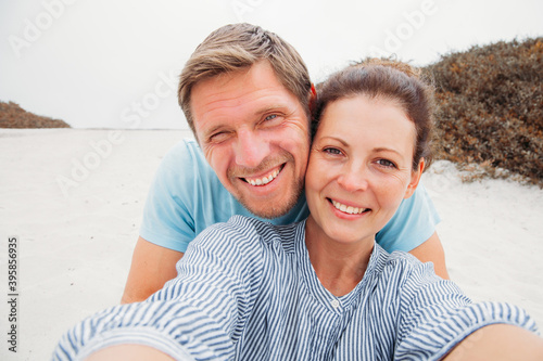 travel, tourism, summer vacation, technology and love concept - happy couple taking selfie with smartphone or camera.In love. happy to be together. sense of freedom. Traveling couple make selfie. 
