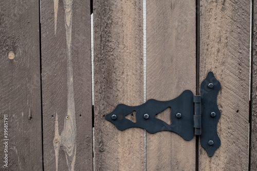 Wood and black metal hardware on a gate