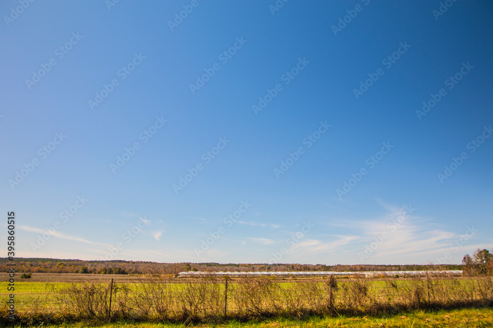 Rural country farm land background blue sky