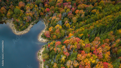 Stunning aerial views of Long Lake Park, Halifax, Nova Scotia, Canada during peak fall/autumn season with mixed color deciduous trees.