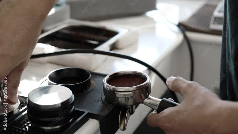 Pressing fresh coffee powder into a pressure press, coffee concept.