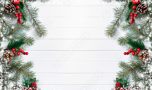 New Year and christmas banner of fir branches and cones on a white wooden background. Winter holidays concept. Flat lay, top view, copy space.