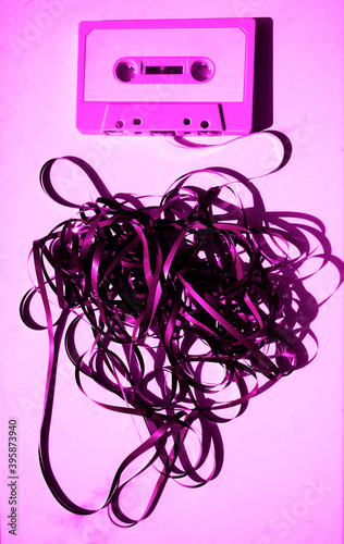 violet Cassette with mess of tape , retro image processed.Common audio cassette with a long playing time photo