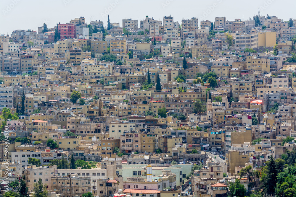 Cityscape of Amman with numerous buildings, the capital and most populous city of Jordan, view from Amman Citadel, known in Arabic as Jabal al-Qal'a.
