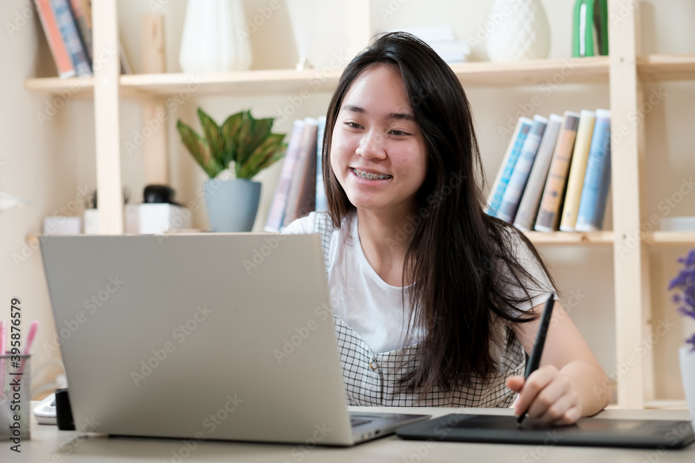 Young girl student studying at home library, using laptop computer, online school concepts,
Young girl student studying at home library, using laptop computer, online school concepts,