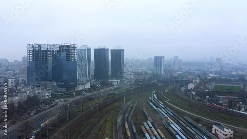 Wallpaper Mural A drone flies over a train station. Aerial top view. Railway sorting station. A lot of wagons at a railway. Flying over railway tracks. 
Railway station on the background of the city in the fog Torontodigital.ca