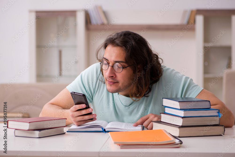Young male student preparing for exams at home Young male student preparing for exams at home