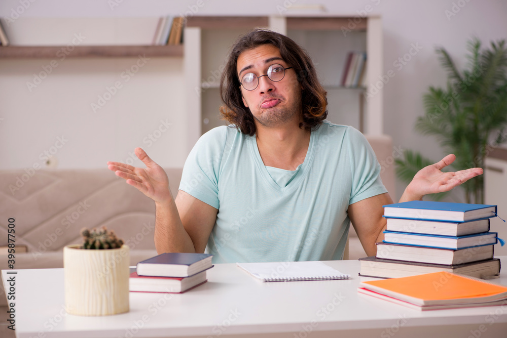 Young male student preparing for exams at home Young male student preparing for exams at home
