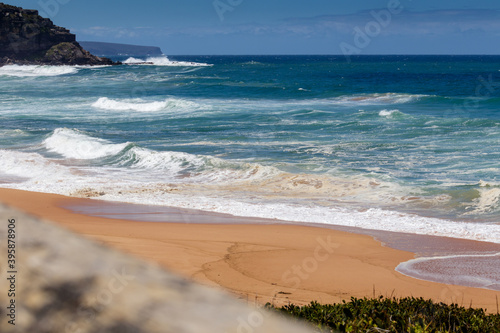 Fototapeta Naklejka Na Ścianę i Meble -  Palm Beach, empty, with ocean views and cliff in the distance, with selective focus on the foreground