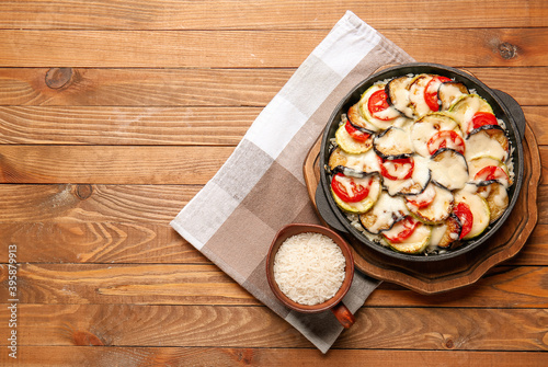 Baking dish with tasty rice casserole on table