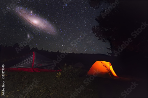 Fantasy background. Tourist tents, a large galaxy in the sky.