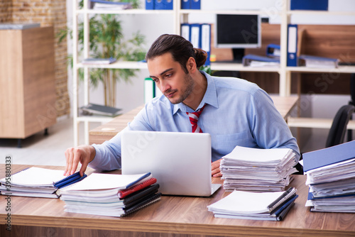 Young male employee unhappy with excessive work