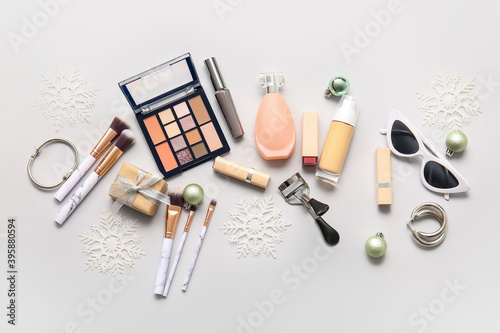 New Year composition with makeup cosmetics on light background