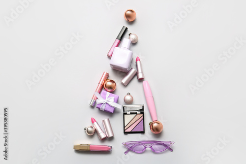New Year composition with makeup cosmetics on light background